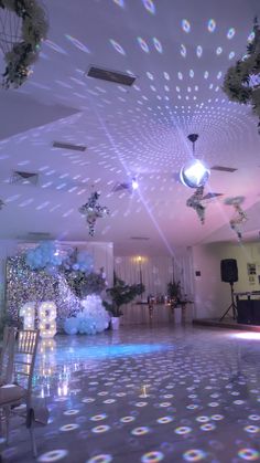 a room that has some lights on the ceiling and decorations hanging from the ceiling in front of it