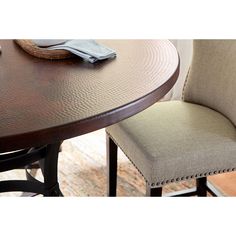 a close up of a table with two chairs and a napkin on top of it