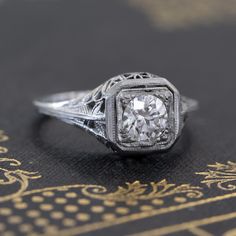 We hope you see the stunning filigree work on this die struck ring! A bright and prismatic old European cut diamond is bead set in an octagon plate, adding generous visual size to the stone (read: the diamond looks much bigger than its stated carat weight!). The ring sits beautifully on the finger - undoubtedly antique, and oh-so special. Classic Octagon Sterling Silver Diamond Ring, Classic Octagon Diamond Cut Jewelry, Silver Octagon Jewelry With Brilliant Cut, Octagon-shaped Diamond Jewelry With Polished Finish, Old European Cut Diamond Ring, Modern Mens Rings, Art Jewelry Earrings, Bespoke Rings, Antique Watches