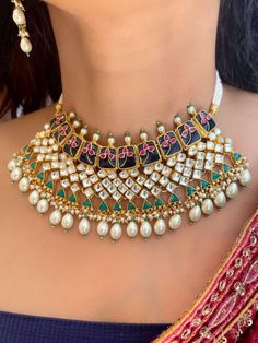 "Explore the intricate beauty of our Meenakari Paachi Kundan necklace set in navy blue, adorned with Kundan, pink ruby, and emerald green stones. Featuring elegant teardrop pearls, this exquisite set blends traditional craftsmanship with vibrant colors, perfect for adding a touch of sophistication to any special occasion. Shop now to elevate your jewelry collection with this stunning piece." Earrings are Approximately 2.7 inches Long  A Earring weight is 0.3 oz Kundan Jewelry With Motifs For Navratri, Navratri Kundan Jewelry With Motifs, Ceremonial Kundan Bridal Necklace With Motifs, Kundan Necklace With Motifs For Festive Occasions, Kundan Necklace With Motifs In Temple Jewelry Style, Ceremonial Meenakari Bridal Necklace For Navratri, Ceremonial Bridal Necklace With Meenakari For Navratri, Multicolor Kundan Necklace With Motifs, Kundan Bridal Necklace With Motifs For Festivals