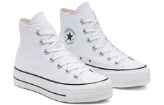 Make a statement with the Converse Chuck Taylor All-Star Hi Platform. Perfect for any occasion, this sneaker will keep you stylish and comfortable in pure white canvas construction. The lace-up closure is secured by matching metallic eyelets and features two inner midfoot eyelets for extra supportive. Along with the rubber toe cap to protect your feet and cushioned insoles, it’s equipped with a sturdy rubber sole provides excellent traction. An iconic look finished off with two black rubber stri All Star Platform, Platform Chucks, Casual Athletic Shoes, Chuck Taylor All Star Lift, Platform Converse, New Converse, Converse White, White Converse, Round Toe Heels