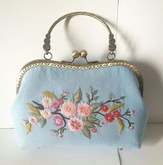 a blue purse with pink flowers on it