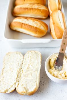 bread and butter are sitting on the counter next to each other, with a spatula in it