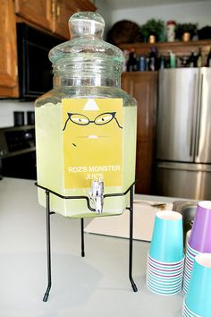 a beverage dispenser sitting on top of a kitchen counter