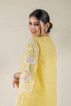 PRODUCT DETAIL: This bright and vibrant set comes laden with a beautiful cutwork embroidery. The lace detailing on the shirt and the tulip pants adds to the beauty of the outfit. *The length of the shirt can be customised. Contact us to get yours as per your preferences. SPECIFICATIONS: Color Yellow Fabric Cotton Product Code RANG18 Traditional Palazzo Set With Embroidered Sleeves, White Designer Sets With Embroidered Sleeves, Designer White Sets With Embroidered Sleeves, Spring Traditional Palazzo Set With Embroidered Sleeves, Designer Lace Work Sets For Spring, Embroidered Long Sleeve Palazzo Set For Wedding, Festive Cotton Sets With Embroidered Sleeves, Spring Cotton Sets With Embroidered Sleeves, Spring Wedding Straight Kurta Top