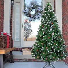 a decorated christmas tree sitting in front of a door