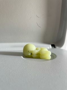 three small yellow candles sitting on top of a white suitcase