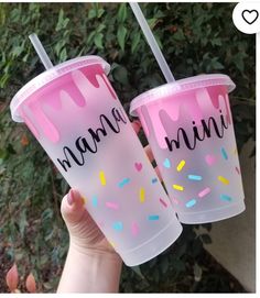 two plastic cups with pink frosting and sprinkles that say mama mia