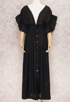 This stunningly bold maxi dress features a lightly textured crepe black dyed fabric. Deep v-neckline and button down front. The relaxed silhouette fits with a drawstring empire waist. Drawstring closure at midriff tightens for a perfect altered look and flawlessly shows off your curves. Pair yours with one our wide brim hats and heeled sandals for a summer inspired look. Composition: 100% Polyester Features: Lightweight Feel Maxi Floor Length Button Down Front Adjustable Drawstring Waistline to Flowy V-neck Maxi Dress With Buttons, V-neck Maxi Dress With Buttons For Daywear, Daywear V-neck Maxi Dress With Button Closure, V-neck Daywear Maxi Dress With Button Closure, V-neck Maxi Dress With Button Closure For The Beach, Bohemian V-neck Dress With Buttons, Bohemian V-neck Buttoned Dresses, Plus Size Beach Dress, Wide Brim Hats