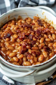 a white bowl filled with baked beans and bacon