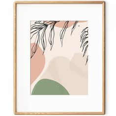 an art print with leaves on it in a wooden frame