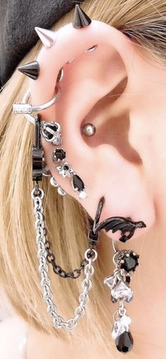 a close up of a person with some piercings on their ears and behind the ear