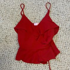 Beautiful Red Spaghetti Strap Tank Top From Pink Lily In Size Small! Never Worn! This Top Has Such Unique Details. This Is A Gorgeous Deep Red Colored Wrap Tank That Ties On The Left. Beautiful Ruffles, A Button Enclosure At The Breast. Absolutely Gorgeous And Flattering! Flirty Red Top With Ruffles, Red Spaghetti Strap Beach Top, Red Ruffle Tops For Brunch, Red Ruffled Tops For Brunch, Red Ruffled Top For Beach, Red Ruffled Tops For Vacation, Red Spaghetti, Strap Tank Top, Ruffle Tank Top