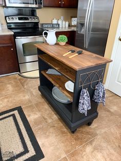 a kitchen island with cutting board on it