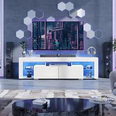 a modern living room with an entertainment center and large screen tv on the wall in front of it