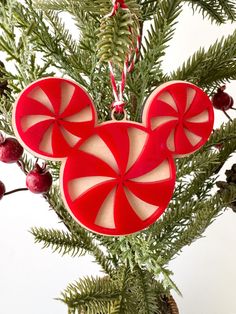 a mickey mouse ornament hanging from a christmas tree