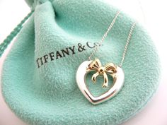 Overview:Here is an awesome Tiffany necklace that you will surely wear over and over again! Offered for sale is a vintage and very pretty Tiffany & Co. Sterling Silver & 18K Gold Heart Ribbon necklace. Classic and elegant piece! The piece is very versatile and will most certainly go perfectly with other pieces of jewelry that you already own. It is a wonderful necklace that fits a lifestyle on the go -- the necklace can be worn to almost any occasion! And because it is two tone, it will Luxury Heart Charm Necklace For Wedding, Luxury Heart Pendant Necklace For Wedding, Luxury Heart-shaped Necklace For Formal Occasions, Luxury Heart Shaped Necklace For Formal Occasions, Luxury White Gold Heart Necklace For Formal Events, Luxury White Gold Heart Necklace For Formal Occasions, Luxury Heart Necklace For Formal Occasions, Luxury Heart Necklace For Valentine's Day Wedding, White Gold Luxury Heart Necklace For Formal Occasions