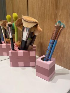 the makeup brushes are in their holders on the table