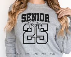 a woman wearing a grey sweatshirt with the number 25 printed on it and black letters