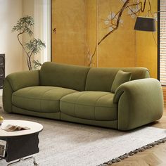 a green couch sitting on top of a rug in a living room