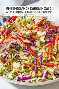 a white bowl filled with coleslaw and carrots on top of a table