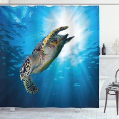 a green sea turtle swimming in the ocean shower curtain set with blue water and sun rays