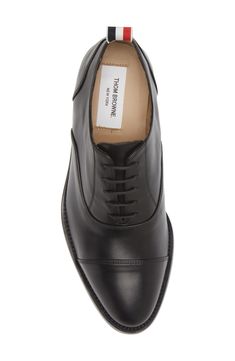 Smart and simple, this Italian-crafted leather oxford features a plain cap toe and minimal detailing to make it a versatile, all-occasion favorite. Lace-up style Leather upper, lining and sole Made in Italy Men's Designer Shoes Plain Toe Oxford With Leather Sole For Work, Classic Oxford Shoes With Brogue Detailing For Work, Timeless Oxfords With Branded Insole For Work, Cap Toe Oxford With Leather Sole For Work, Cap Toe Oxford Shoes With Rubber Sole For Work, Classic Oxford Shoes With Rubber Sole For Work, Leather Plain Toe Oxford Shoes For Work, Classic Cap Toe Leather Shoes, Classic Leather Cap Toe Shoes With Rubber Heel Cap