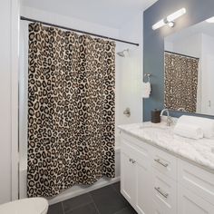 a bathroom with a leopard print shower curtain