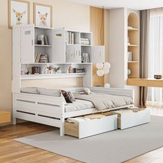 a white bed sitting in a bedroom on top of a hard wood floor next to a book shelf