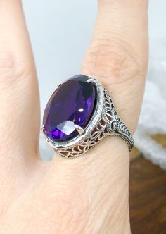 Natural Purple Amethyst Ring  Persian Design#230 Custom Made  This is a brand new stunning Art Nouveau/Vintage designed sterling silver filigree 10.54ct oval Natural Purple Amethyst ring. The Flawless oval full cut high-quality Amethyst is 18mm (just shy of 3/4th of an inch) by 13mm (1/2 inch) in dimension... This ring is 21mm North South on the finger. The inside of the band is marked 925 for sterling. Notice the beautiful filigree swirl like the craftsmanship of the silver setting. This lovely Victorian Amethyst Ring With Accent Stones For Formal Occasions, Classic Oval Purple Amethyst Ring, Antique Amethyst Ring With Accent Stones For Formal Occasions, Oval Sterling Silver Filigree Amethyst Ring, Oval Amethyst Ring With Filigree In Sterling Silver, Oval Amethyst Ring With Filigree Detail, Oval Amethyst Collectible Ring, Ornate Hallmarked Amethyst Ring For Formal Occasions, Oval Amethyst Ring For Formal Occasions