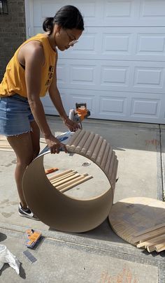 a woman is sanding up furniture outside