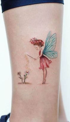 a woman's thigh with a tattoo on it that has a fairy holding a flower