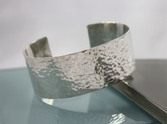 "This Sterling Silver cuff bracelet is everyday awesome.. Just over 1\" wide this adjustable cuff has long lasting durability for everyday wear. Keep it shiny, or let time add a lovely patina to this lifetime piece of jewelry. This statement cuff will add alot of sparkle and boho flair to just about any wardrobe. This bracelet was hand forged from a sheet of Recycled Sterling Silver, shaped, hammered, tumbled and polished here in my Northern California studio. All items are boxed in a recycled p Silver Arm Cuff, Modern Bangle, Hammered Cuff Bracelet, Hammered Bracelet, Sterling Bracelets, Hammered Sterling Silver, Simple Bracelets, Sterling Silver Cuff Bracelet, Sterling Silver Hoop Earrings