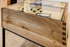 a wooden table with glass top in a room