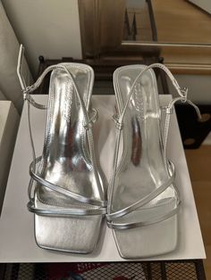 Never worn silver heels. Heel height: 5.5cm/2.1" size 8. Runs big Metallic Heels With Sculpted Block Heel, Silver Block Heels With Round Toe For Summer, Summer Silver Block Heels With Round Toe, Silver Heels With Stacked Heel For Summer, Silver Block Heels With Heel Strap For Party, Summer Silver Heels With Stacked Heel, Elegant Metallic Square Toe Heels, Silver Block Heels With 4-inch Heel, Silver Kitten Heels For Summer Parties