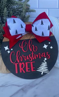 a christmas tree sign with a bow on it