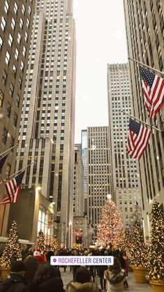 the rockefeller christmas tree in new york city is lit up with american flags and garlands