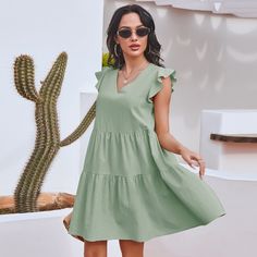 The EMES SHOP dress is detailed with gorgeous ruffle sleeves. Features a v neck line. shift dress silhouette. tiers. and an above knee length. Pair it with a hat and espadrilles for a refreshing summer look.MATERIAL:100% Soft Cotton MEASUREMENTS:Dress Length is 35-37"in Small | Bust & Waist: 37"-39"in Medium | Bust& Waist: 39"-41"in Large | Bust& Waist: 41"-43in V-neck Tiered Dress With Ruffle Hem For Vacation, V-neck Tiered Dress With Ruffle Hem For Beach, Casual Green Mini Dress With Flutter Sleeves, Solid Color Tiered Mini Dress For Summer, Solid Tiered Mini Dress For Summer, Tiered Solid Mini Dress For Summer, Bohemian Tiered Short Sleeve Dress For Summer, Bohemian Tiered Dress With Short Sleeves For Summer, Chic Plain Color Tiered Dress For Summer