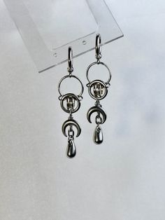 These grunge, cyber-punk earrings feature an intricate ring pattern with a devilish crescent moon and teardrop suspended below. They're so unique and their androgynous nature makes them the perfect piece for masculine, feminine, or any look in between.  This piece is made from stainless-steel and silver-plate. They're hypoallergenic, as well as lead and nickel-free. For optimal care, be sure to limit exposure to excess moisture.  Shipping information: The shipping I provide to Canada and UK is U Intricate Rings, Big Statement Earrings, Moon Drop, Ring Pattern, Earrings Moon, Punk Earrings, Masculine Feminine, Grunge Goth, Crescent Moon