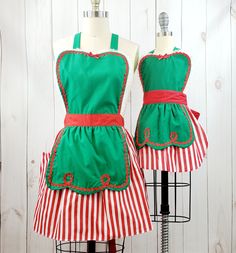 two mannequins dressed in green and red striped aprons, one is wearing an apron