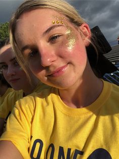 Glitter Cheer Makeup, Game Day Glitter Face, Gold Cheer Makeup, Gold Outfit Spirit Week, Glitter On Face Football Game, Cheer Makeup High School Glitter, Blue And Gold Spirit Day, Yellow Team Spirit Outfits, Cheer Glitter Face