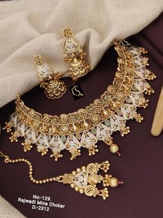 Description :- NecklaceWith Earrings/Handmade Necklace/Kundan Choker/Beaded Necklace/set for wedding/sangeet ceremany jewellery Indian Wedding Jewelry 100% Satisfaction. Long Lasting Plating, High-Quality Stones. Gifting :- This Earrings comes in a beautiful manalisstudio gift box, making it an ideal gift for birthdays, weddings or anniversaries. Occasion :- Perfect choice for any Indian occasion. Care: 1.It Is Advisable That You Keep Products Away From Direct Heat, Humidity, And Moisture. It Is White Chandbali Bridal Sets For Ceremonies, Gold Bollywood Lehenga For Marriage, Bollywood Style Gold Lehenga For Marriage, Festive Kundan Lehenga For Marriage, Festive Gold Lehenga For Marriage, Kundan Bridal Earrings For Marriage, White Kundan Necklace With Intricate Design For Marriage, White Kundan Meenakari Wedding Jewelry, White Kundan Bridal Sets For Ceremonial Occasions