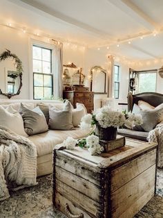 a living room filled with furniture and lots of lights hanging from the ceiling above it