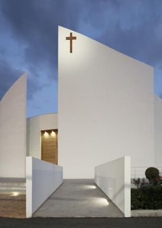 a white church with a cross on the wall