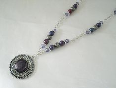 "Hidden Pentacle Necklace This beautiful necklace has purple glass beads, silver plated beads, silver plated chain, pewter silver pendant with purple acrylic setting and a hidden pewter silver pentacle on back. Very discreet. 20\" long. Sterling silver plated lobster clasp." Bohemian Silver Amethyst Beaded Necklace, Gothic Silver Beaded Necklace Perfect For Gifts, Silver Gothic Beaded Necklace As Gift, Silver Gothic Beaded Necklace For Gift, Gothic Silver Necklaces With Round Beads, Silver Gothic Necklaces With Round Beads, Gothic Silver Necklace With Round Beads, Spiritual Silver Beaded Necklace With Round Pendant, Nickel Free Purple Metal Necklace