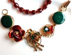 An exceptional Christmas bracelet made from reclaimed TRUE vintage clip earrings, vintage jewels and a 1940's Austrian brooch.   This is a one-of-a-kind creation that will look lovely gracing your wrist for the holidays. It is very feminine and done in elegant greens, reds and gold on a goldplated bracelet.  From left to right we have a high-end green and gold earring that was a clip-back.  It is swirled enamel (looks as if a little cream was swirled through it) and has a high-low effect with one side dipping lower than the other.  Very interesting !  Next is a 1960's golden flower drenched in gleaming glossy ruby red enamel.  The centerpiece was a 1940's brooch marked Austria.  It has a lovely cascading style, emerald crystal center and 6 small rhinestones on the ribbon tails.  Fourth is Red Retro Brooch Jewelry, Retro Red Brooch Jewelry, Retro Green Jewelry For Vintage Events, Vintage Jewelry For Holiday Parties, Vintage Holiday Jewelry For Party, Vintage Holiday Party Jewelry, Holiday Party Vintage Jewelry, Vintage Necklaces For Christmas Gifts, Vintage Necklace For Christmas Gift