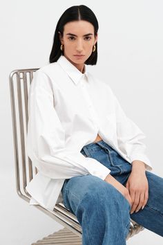 Relaxed and feminine, our oversized Raphaela Shirt is a true dream. Fashioned from crisp European poplin cotton, she's tailored with a sharp collar and a button front, which evens out her floaty shape and dolman sleeves. | Emily, in white, is 5'9.5" (177 cm) tall, wearing size XS. Approximately 29.5" (75 cm), measured from the shoulder to the bottom hem. Sleeve length approximately 22.5" (57.5 cm).100% European Poplin Cotton. Machine wash on delicate cycle or hand wash in cold water. Tumble dry Oversize Shirt, Boyfriend Shirt, Winter Clothing, The A Team, Oversized Shirt, Dolman Sleeve, Shirt Outfit, Cold Water, Winter Outfits