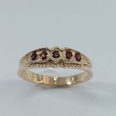 This stunning  style ring has been carefully crafted from scratch in 10k Solid Yellow Gold, and authentic garnet stone. Great for any occasion! Buy it for your-self or for someone you love! This beautiful ring will not go unnoticed. All of my jewelry is handmade from scratch and of high quality. A tracking shipping number will be provided to you once ring has been mailed. Ring Measurements and Materials: Ring is size 7 but can be resized at no extra cost and will be shipped to you in an elegant Gold Garnet Birthstone Ring, Gold Garnet Cluster Promise Ring, Classic Garnet Round Band Rings, Oval Garnet Signet Ring For Anniversary, Classic Garnet Birthstone Ring For Anniversary, Classic Garnet Ring With Round Band, Vintage Garnet Birthstone Promise Ring, Vintage Garnet Birthstone Rings, Heirloom Garnet Ring For Formal Occasions