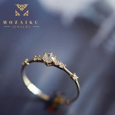 "Our absolute favorite -- Mozaiku's 7 Rocks, Gold Or Sliver Ring - is this gorgeous Japanese inspired Fine Band Ring that will add that sophisticated edge to any outfit, as it's so noticeably small yet striking. You can get it in 14kt plated yellow gold or S925 silver, featuring 7 diamond-cut zircon stones. Specification:      Material - 925 silver     Plating -14 k gold     Stones - Zircon diamonds     Color - Gold, silver white     Made by mozaiku      Custom made to order NEW STORE OPENING 8 WEEKS EXCLUSIVE OFFER. LIFETIME WARRANTY  Time and time again, we come across products that break the next day after you buy them.  That's not going to happen for you at our store, Mozaiku.  You can buy Mozaiku with peace of mind knowing that we will fix anything that happens to our jewels.  We are Gold Sterling Silver Solitaire Crystal Ring, Gold Sterling Silver Crystal Wedding Ring, Gold Sterling Silver Crystal Ring For Wedding, Gold Solitaire Crystal Ring In Sterling Silver, Silver Crystal Ring In 14k Gold, Silver 14k Gold Crystal Ring, Dainty Crystal Ring In Silver And 14k Gold, Dainty Silver Crystal Ring In 14k Gold, Gold Sterling Silver Crystal Promise Ring