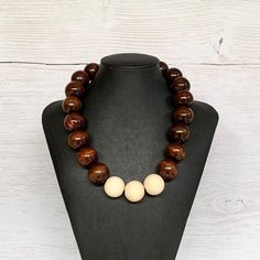 This unisex wood bead necklace was hand beaded using a mix of large 25mm round dark brown and pale oak wooden beads in a modern bohemian design. The necklace measures 19 inches long and is securely fastened with a silver clasp.  Perfect for any gender!  Length can be adjusted if needed - just ask! Wood represents a sense of earthiness, spirituality, creativity, liberty, prosperity, health, and natural touch.  Perfect for meditation, prayer, yoga practices, and everyday wear!    Check out more fa Adjustable Round Brown Beaded Necklace, Adjustable Brown Round Beaded Necklace, Adjustable Brown Beaded Round Necklace, Adjustable Brown Beaded Necklace, Wooden Beaded Necklaces With Round Beads, Wooden Beaded Necklace With Round Beads, Wooden Jewelry With Large Round Beads, Brown Wooden Beads Round Jewelry, Brown Wooden Beads Jewelry